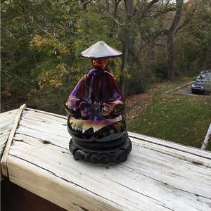 Heavy, solid glass of an Asian woman seated